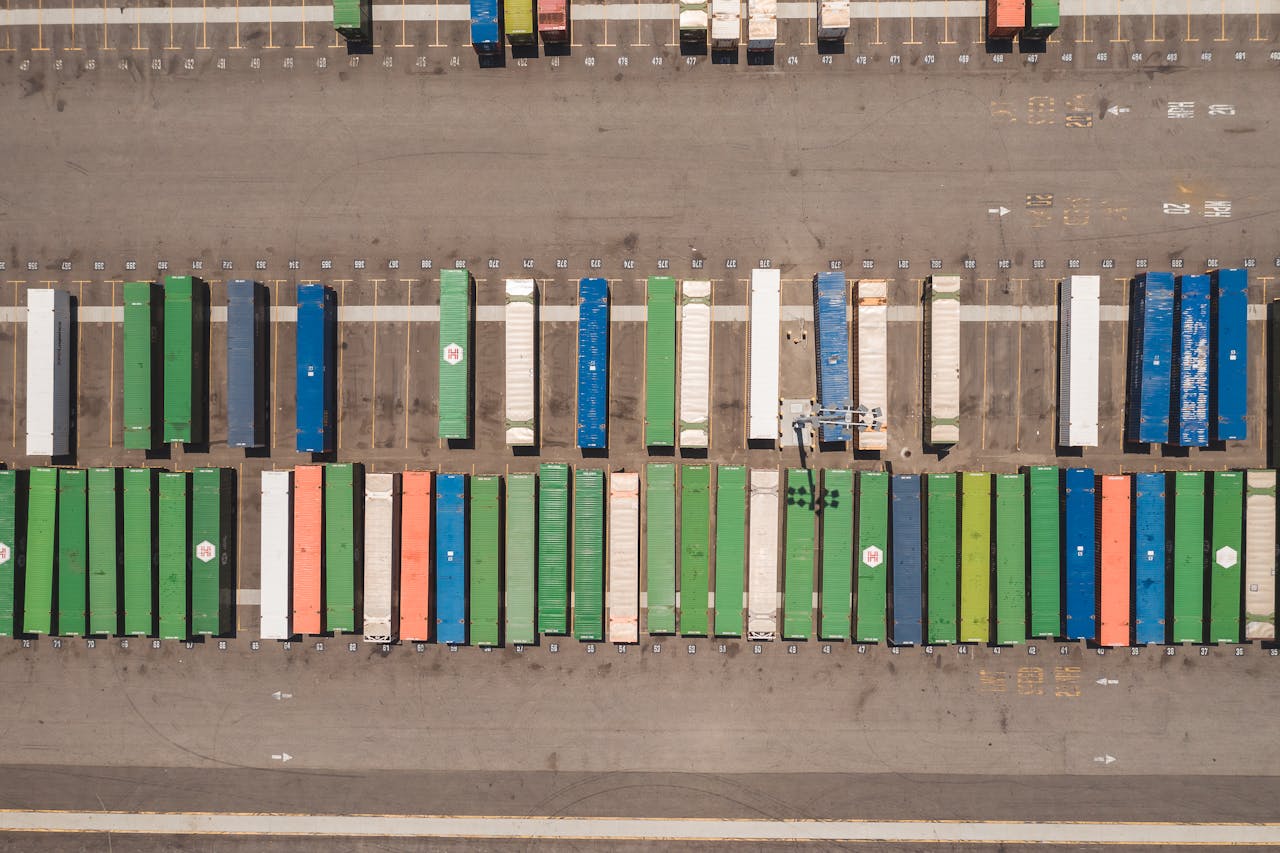 about-01 Top view of neatly arranged cargo containers in a shipping port, highlighting logistics and global trade.