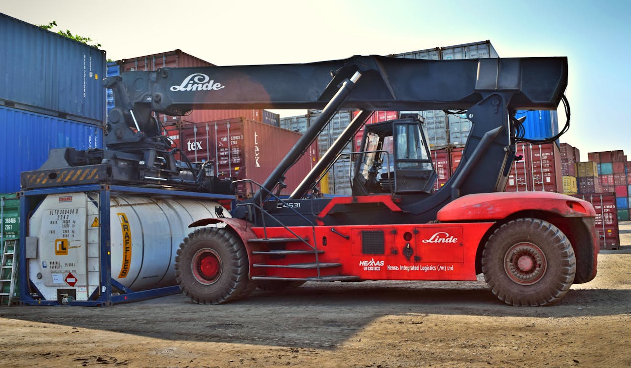 services-01 Forklift operating at a cargo yard, moving large containers efficiently.